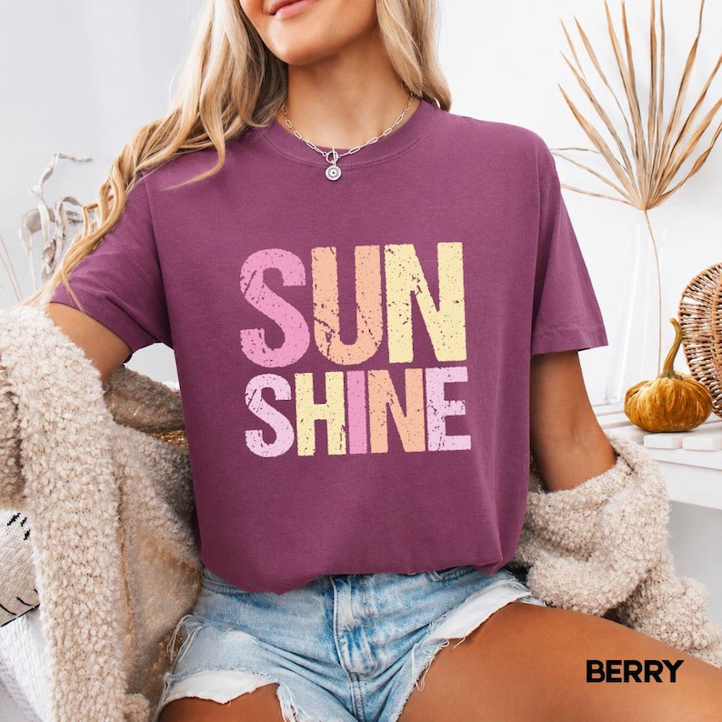 Berry t-shirt with 'SUNSHINE' graphic in pink, yellow, and orange lettering