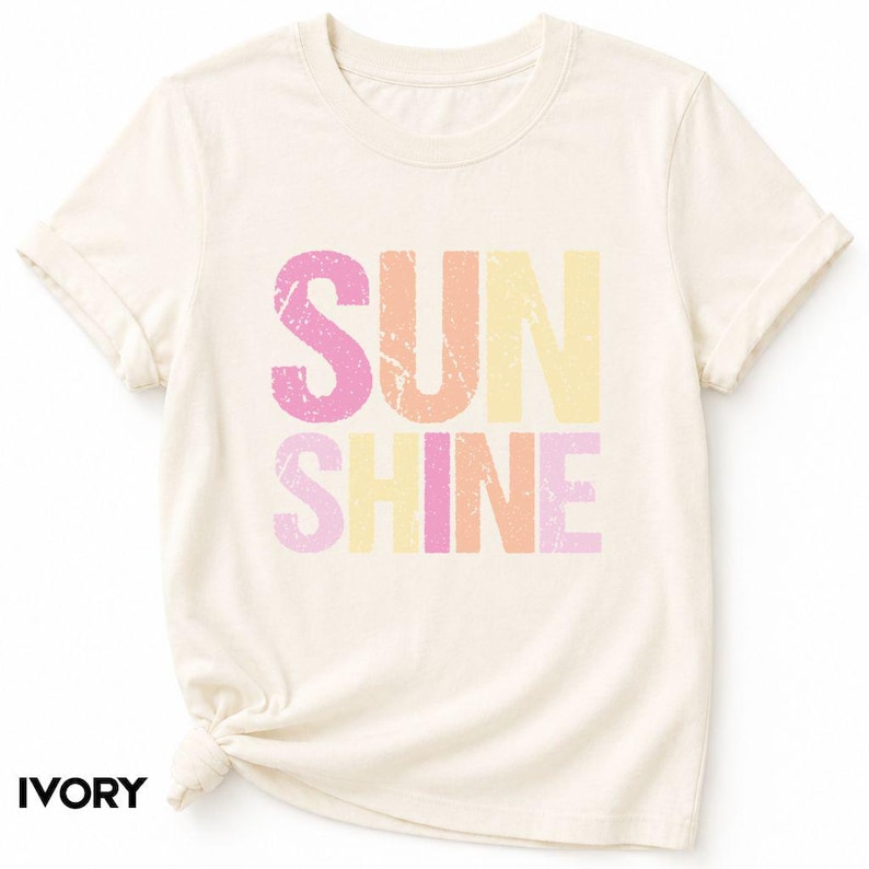 Ivory t-shirt with 'SUNSHINE' graphic in pink, orange, and yellow lettering