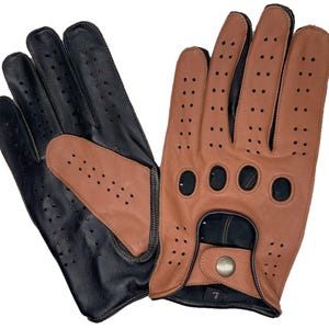 May include: A pair of driving gloves in black and tan leather. The gloves have a perforated design for breathability and a snap closure. The gloves are size 7.