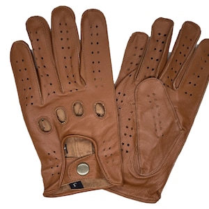May include: A pair of brown leather driving gloves. The gloves have numerous small perforations for ventilation and feature a snap closure at the wrist. The leather is a warm, medium brown color.