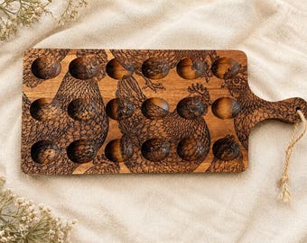 May include: A rectangular wooden egg holder tray featuring a laser-engraved pattern of chickens across the surface. The tray includes eighteen circular indentations for eggs, a handle on the right side, and a piece of twine attached for hanging.