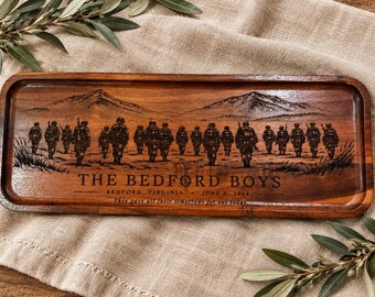 May include: A rectangular wooden tray featuring a laser-engraved scene of soldiers walking across a landscape. The text reads THE BEDFORD BOYS, BEDFORD, VIRGINIA, JUNE 6, 1944, and They gave all their tomorrows for our today, centered below the figures.