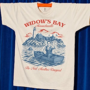 Widow's Bay TV Show t-shirt with vintage travel poster art and sea hag on a unisex comfort colors graphic tee