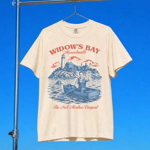 Widow's Bay TV Show t-shirt with vintage travel poster art and sea hag on a unisex comfort colors graphic tee