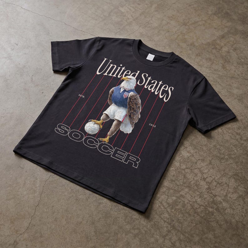 Vintage USMNT soccer fan graphic t-shirt with bald eagle soccer player and pinstripes on a black graphic tee of USA world cup soccer fans