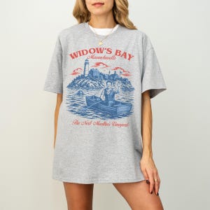 Widow's Bay TV Show t-shirt with vintage travel poster art and sea hag on a unisex comfort colors graphic tee