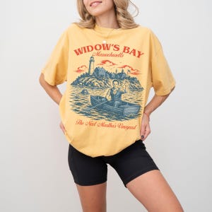 Widow's Bay TV Show t-shirt with vintage travel poster art and sea hag on a unisex comfort colors graphic tee