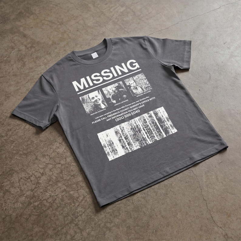 May include: Gray t-shirt with the word "MISSING" in large white letters. Below are three black and white photos and text that reads "PLEASE CALL FREDERICK COUNTY SHERIFF'S OFFICE WITH ANY INFORMATION YOU MAY HAVE (301) 555-1040."