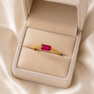 925 Sterling Silver Gold Plated Ruby gemstone ring with twisted gold band presented inside a soft beige jewelry ring box.