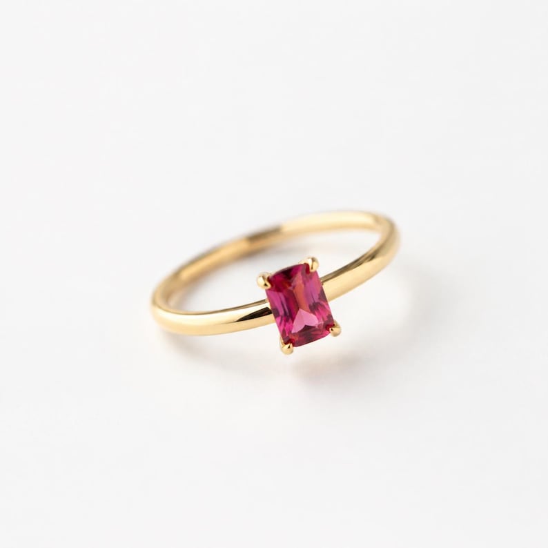 925 Sterling Silver Gold Plated Minimalist emerald pink ruby gemstone ring with a slim polished gold band photographed on a clean pure white surface.
