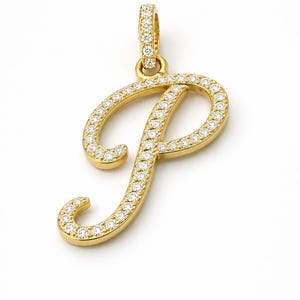 May include: A gold pendant in the shape of the cursive letter P, featuring a polished gold finish and a series of small, clear, round-cut stones set along the entire front surface of the letter and the attached circular bail at the top.