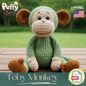 May include: A handmade crochet monkey toy in shades of green, tan, and brown. The toy has a smiling face, large ears, and is labeled "Toby Monkey". The "Puffy Cherry" logo is in the top left corner. The image also includes a PDF icon.