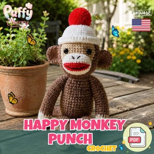 May include: A handmade crochet sock monkey with a white hat, red pom-pom, and red mouth. The monkey is brown with white accents and is sitting on a wooden surface. The text "HAPPY MONKEY PUNCH CROCHET" is displayed below the monkey.