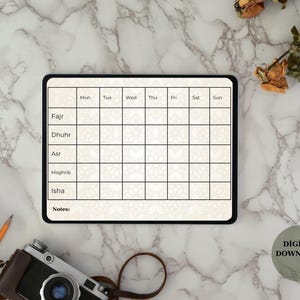 May include: Digital download of a daily prayer tracker on a tablet. The tracker has sections for Fajr, Dhuhr, Asr, Maghrib, and Isha, with days of the week across the top. The background is a marble pattern.