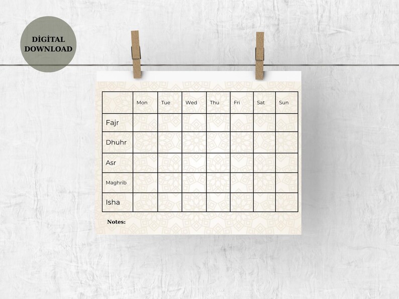 May include: A beige digital download printable calendar with a decorative pattern, held by two wooden clips. The calendar grid is for daily tracking of Fajr, Dhuhr, Asr, Maghrib, and Isha prayers, with space for notes. The words "DIGITAL DOWNLOAD" are in a circle.