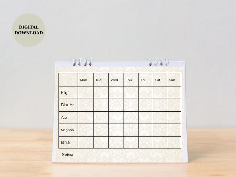 May include: A spiral-bound desk calendar with a cream-colored background and a geometric pattern. The calendar grid is divided into days of the week, with spaces for prayer times: Fajr, Dhuhr, Asr, Maghrib, and Isha. The words "DIGITAL DOWNLOAD" are in a circle.