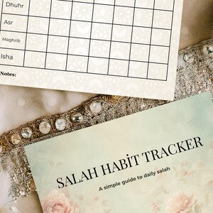 May include: Two printed sheets with a floral design and the text "SALAH HABIT TRACKER" and "A simple guide to daily salah". The top sheet has a grid for tracking daily activities.