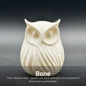 May include: A small, off-white, 3D-printed owl figurine with a smooth, rounded body and textured feather details. The owl features prominent ear tufts and large, circular eyes. The text "Bone" is printed at the bottom of the image.