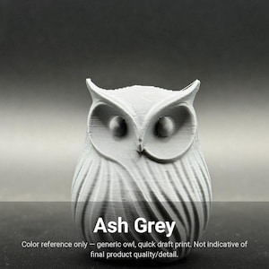 May include: An ash grey 3D printed owl figurine featuring a textured surface with visible horizontal layer lines, prominent ear tufts, and circular eye sockets. The text Ash Grey is printed at the bottom of the image.