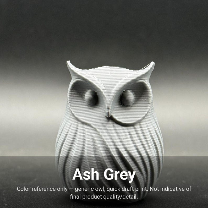 May include: An ash grey 3D printed owl figurine featuring a textured surface with visible horizontal layer lines, prominent ear tufts, and circular eye sockets. The text Ash Grey is printed at the bottom of the image.