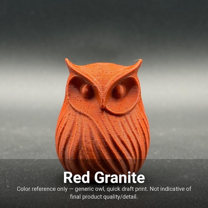 May include: A small, red granite-colored owl figurine with a textured, layered surface finish. The owl features prominent ear tufts, circular eyes, and stylized wing feathers. The text 'Red Granite' is printed below the owl figure.