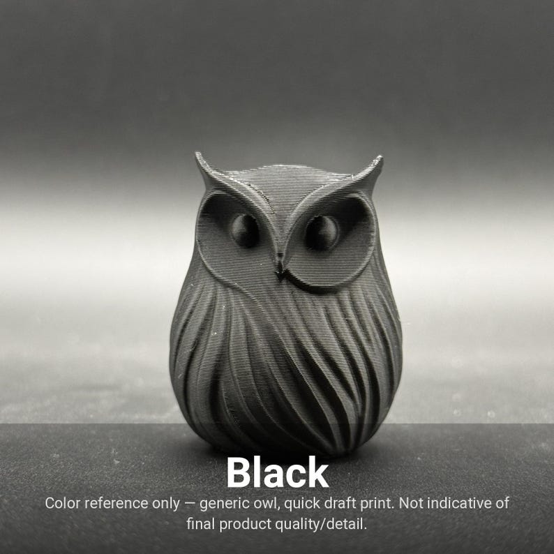 May include: A matte black owl figurine featuring a textured surface with visible horizontal print lines. The owl has large, rounded eye sockets and pointed ear tufts. The text "Black" is printed below the owl, followed by "Color reference only - generic owl, quick draft print. Not indicative of final product quality/detail."