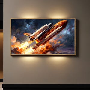 May include: A framed print showing a space shuttle taking off. The shuttle is orange and white, with flames and smoke. The background is a dark blue sky with swirling clouds and stars. The artwork is displayed on a neutral wall, illuminated by spotlights.