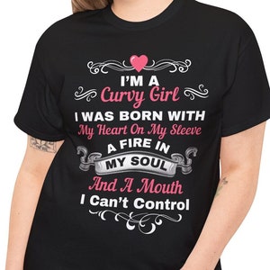 May include: Black t-shirt with a white graphic that says "I'm a Curvy Girl I was born with my heart on my sleeve a fire in my soul and a mouth I can't control". The graphic includes a pink heart.