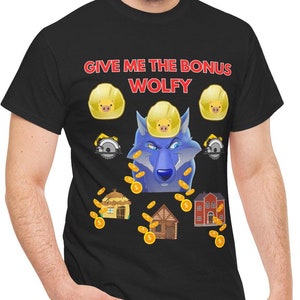 May include: A black t-shirt with the text "GIVE ME THE BONUS WOLFY" in red. The design features a blue wolf wearing a yellow hard hat, surrounded by gold coins and small houses.