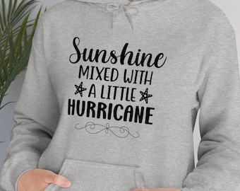 May include: Gray hooded sweatshirt with black text that reads "Sunshine mixed with a little hurricane" with a starfish on either side of the word "little".