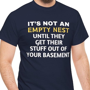 May include: A navy blue t-shirt with white text that reads "It's not an empty nest until they get their stuff out of your basement".
