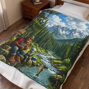 May include: A colorful blanket featuring a whimsical scene of Bigfoot and an alien fishing in a mountain stream. The artwork includes a detailed landscape with a forest, mountains, and a fish jumping out of the water. The blanket is on a bed.