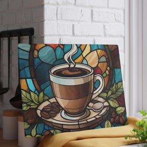 May include: A decorative coffee-themed artwork featuring a steaming cup of coffee on a saucer with coffee beans and a spoon. The background is a stained-glass design with blue, yellow, and red hues. The artwork is displayed on a window sill.