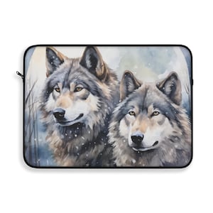 May include: Laptop sleeve featuring a watercolor painting of two wolves in a snowy forest scene. The wolves have gray and brown fur, with yellow eyes. The background includes bare trees and a soft, blue and white color palette.