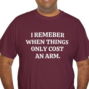 May include: A maroon t-shirt with white text that reads "I remeber when things only cost an arm."