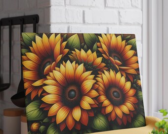 May include: A rectangular canvas print featuring a vibrant floral arrangement of sunflowers. The sunflowers have yellow and orange petals with dark brown centers, surrounded by green leaves. The artwork is displayed on a yellow cloth.