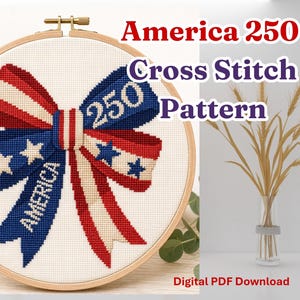 May include: A cross-stitch pattern in a wooden hoop features a patriotic bow design with red, white, and blue colors. The bow includes the text "America" and "250". The words "Cross Stitch Pattern" are also visible.