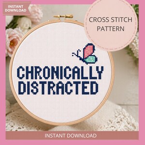 May include: A cross-stitch design in a wooden hoop, featuring the text "CHRONICALLY DISTRACTED" in navy blue. A butterfly with pink and teal wings is above the text. The words "CROSS STITCH PATTERN" and "INSTANT DOWNLOAD" are also visible.