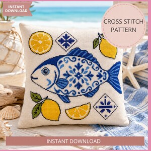 May include: A cross-stitch pattern on a pillow featuring a blue and white fish design, lemons, and geometric shapes. The pillow is on a blue and white striped surface with a starfish. The text "Instant Download" and "Cross Stitch Pattern" are visible.