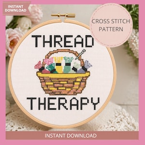 May include: A cross-stitch pattern in a wooden hoop. The design features a basket filled with colorful thread spools and the words "THREAD THERAPY". A pink banner at the top says "INSTANT DOWNLOAD".