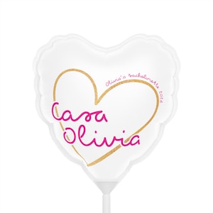 May include: A white heart-shaped balloon with a gold heart outline. The balloon features the pink cursive text "Casa Olivia" and the text "Olivia's bachelorette 2026" in pink.
