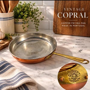 May include: A round copper frying pan with a silver-toned interior and a long brass handle. The pan features a circular stamp on the handle base that reads COPRAL MADE IN PORTUGAL. The text VINTAGE COPRAL COPPER FRYING PAN MADE IN PORTUGAL is visible.