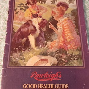 May include: A vintage Rawleigh's Good Health Guide and Cook Book with a purple cover. The front features a color illustration of two children interacting with a dog in a field, with the text Rawleigh's Good Health Guide and Cook Book printed below.