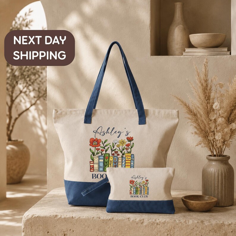 a large tote bag with a floral design and the name "Ashley's Book Club" printed on it, along with a smaller bag below it. The bags are placed on a table, and there is a vase of flowers and a bowl nearby. The background includes a bookshelf and a sign that says "Next day shipping".