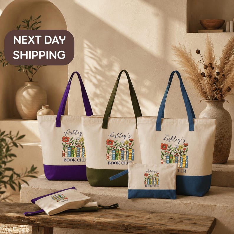 a collection of tote bags and a small bag, all with the same design and branding, arranged on a wooden surface.