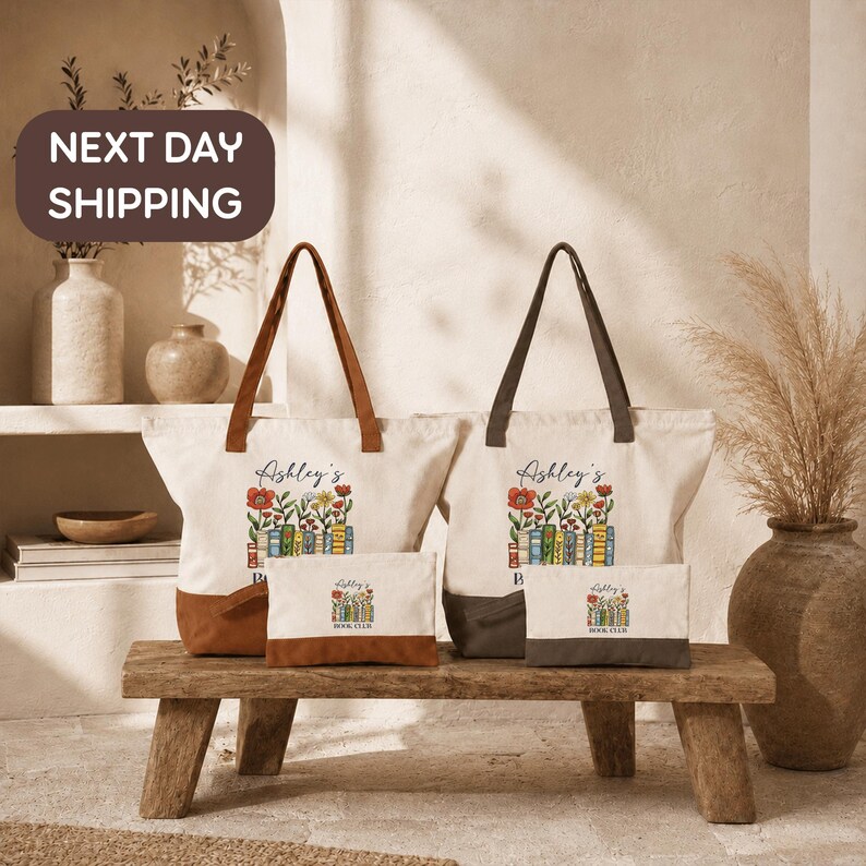 a set of four tote bags with floral designs, placed on a wooden bench. The bags are white with brown handles and appear to be made of canvas material. The bags are arranged in a row, with two on the left and two on the right. The background includes a shelf with decorative items, such as vases and a potted plant, creating a cozy and homely atmosphere.