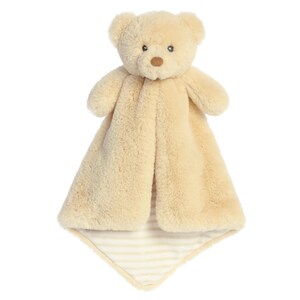 May include: A beige plush security blanket with a bear head attached. The blanket has a striped pattern on the back.