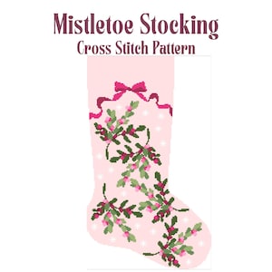May include: A pink cross-stitch pattern for a Christmas stocking. The stocking features a design of green mistletoe with red berries and white snowflakes. The top of the stocking has a pink bow and ribbon. Text at the top reads "Mistletoe Stocking Cross Stitch Pattern."