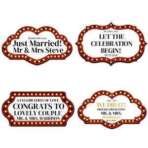 May include: Four decorative wedding signs with a red and gold border and illuminated bulbs. The signs feature phrases like "Just Married!" and "Let the Celebration Begin!" with names and dates.