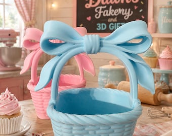 May include: A light blue basket with a woven texture and a large bow handle, positioned in front of a pink basket of the same design. The baskets feature a rounded base and a decorative twisted rim, showcasing a smooth, solid-colored finish.